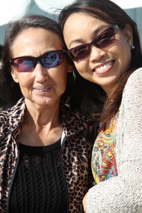 two women wearing sunglasses posing and smiling