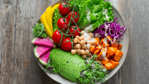 a colorful bowl of vegetables with avocado
